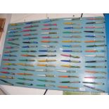 A collection of novelty pens on presentation board