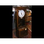 An oak cased antique electric clocking-in clock -