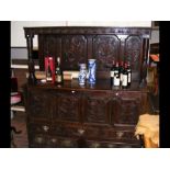 A period oak court cupboard with caved panel front