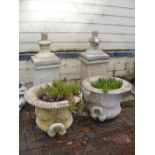 A pair of 130cm high concrete garden urns on plint