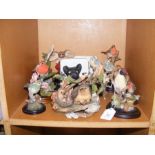 A quantity of sculpted bird figurines, together wi
