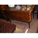 A 19th century Pembroke table on square tapering s