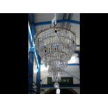 A decorative antique six tier crystal ceiling ligh