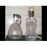 A silver top decanter and one other