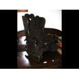 A small antique carved oak child's rocking chair