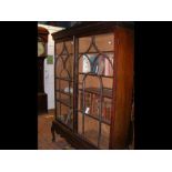 An antique two door bookcase on cabriole supports