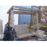 A wooden garden swing bench