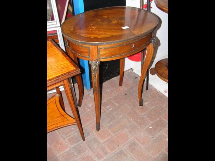 A small oval French side table with marquetry top