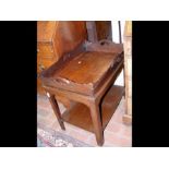 A wooden butlers tray on stand