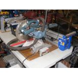 An Erbauer 254mm sliding mitre saw, together with