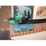 A petrol powered chainsaw, together with Makita dr