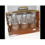 A tantalus set of three glass decanters