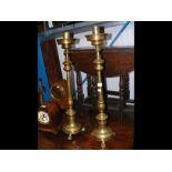 A pair of decorative ecclesiastical brass candlest