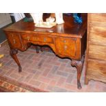 A walnut lowboy on carved cabriole supports termin
