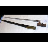 An old military sword bayonet with leather scabbar