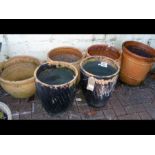 Six terracotta garden pots of varying shapes and s