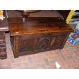 A period oak panelled coffer with carved decoratio