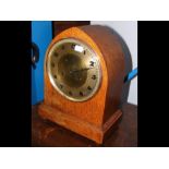 A lancet shaped oak mantel clock - 33cm high