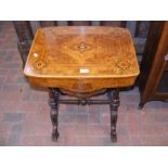 A Victorian walnut work table with fitted interior