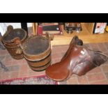 An old riding saddle and two coopered buckets