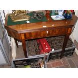 An early 19th century mahogany fold over tea table