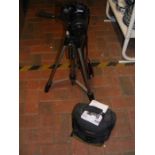A Canon EOS 550D camera on tripod together with manual and carrying case