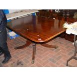 A 19th century mahogany tilt-top dining table on c