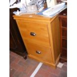 An oak two drawer filing cabinet
