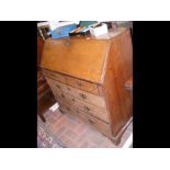 A Georgian oak bureau with fitted interior and dra