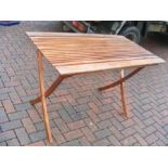 A teak collapsible garden table - length 120cms