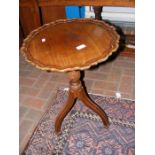 A mahogany wine table with pie crust edge