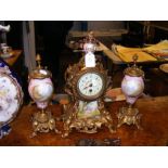A French gilt metal and porcelain clock garniture