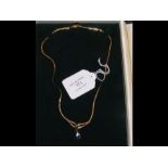 A 9ct gold necklace with sapphire and diamond pend