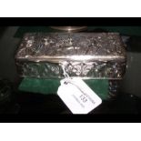 An embossed silver box with classical style decora