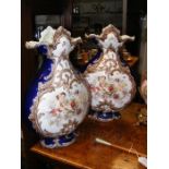 A pair of Victorian vases with cherub decoration -