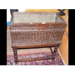 A 17th century style carved oak planter with metal