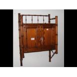 A Howard & Sons pitch pine bamboo design wall cabi