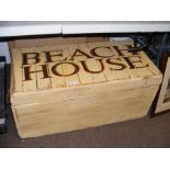 A pine chest inscribed 'Beach House' to the lid