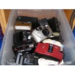 A box of vintage cameras, including Kodak and Prak