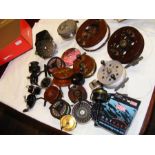 An assortment of fishing reels, some wooden - on t
