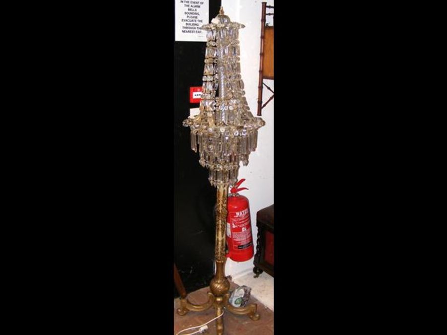 A gilt decorated standard lamp with glass lustre s