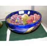 A Moorcroft blue ground bowl with tube lined decoration - 20cm diameter