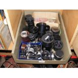 A box of assorted telescopic lenses and other phot