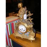 A French gilt metal and porcelain mantel clock wit
