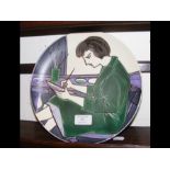 A rare Poole Pottery plate depicting a potter at w