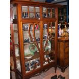 An Art Nouveau style display cabinet with bow glas