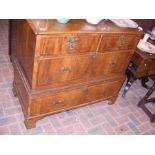 A walnut and oak chest of two short and two long d