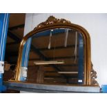 A reproduction Victorian style gilt overmantel wit