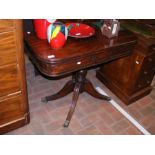 A 19th century mahogany fold over card table on qu