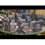 Nine vintage folding cameras including Zeiss Ikon